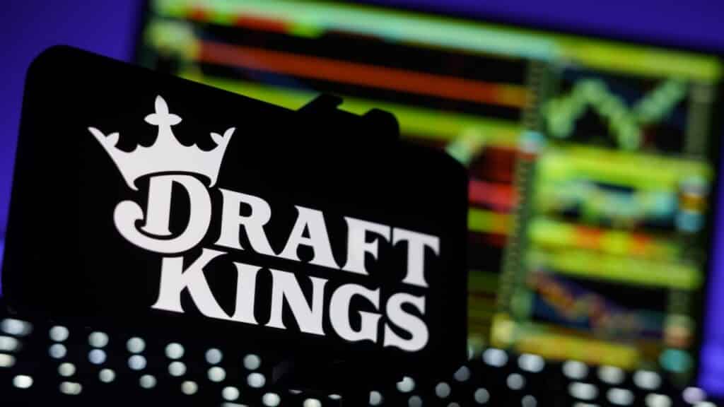 DraftKings Logo On Mobile And Computer Screens With Chart Background