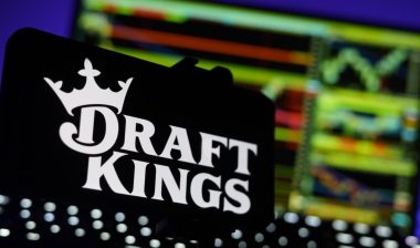 DraftKings Logo On Mobile And Computer Screens With Chart Background