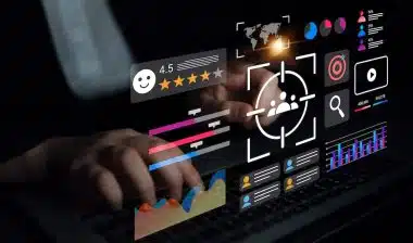A person interacts with a laptop, surrounded by a dynamic digital interface showcasing various metrics