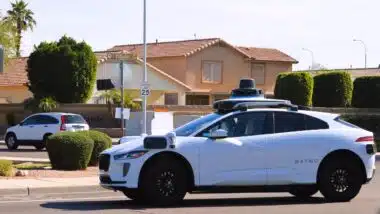 A Waymo self driving autonomous taxi in a residential neighborhood