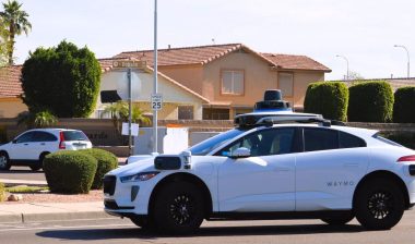A Waymo self driving autonomous taxi in a residential neighborhood