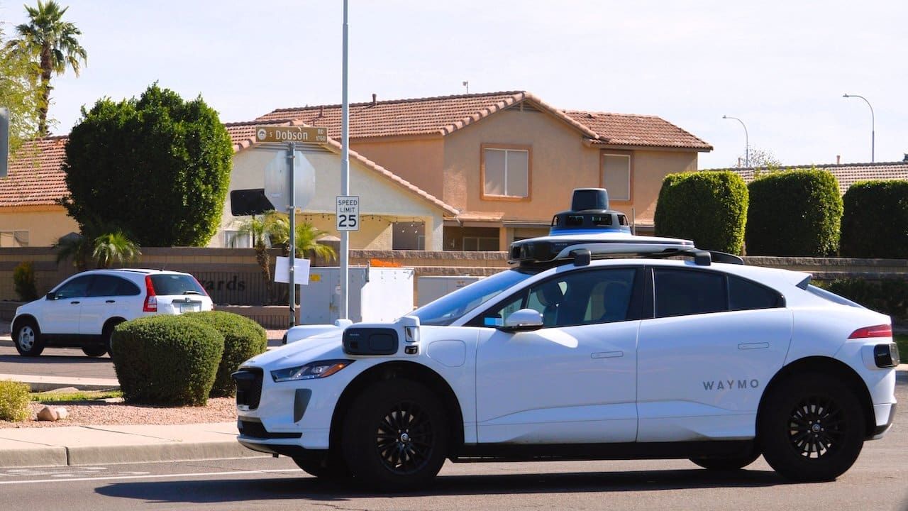 A Waymo self driving autonomous taxi in a residential neighborhood