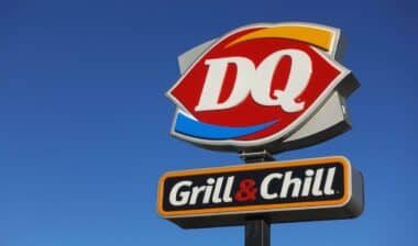 Close up of a Dairy Queen store sign in a deep blue sky