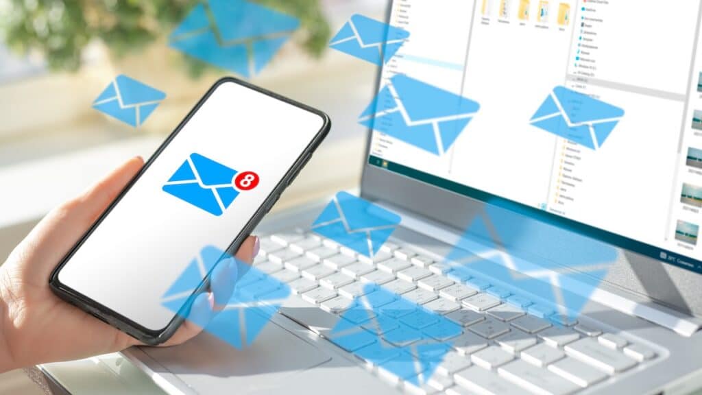 cell phone and laptop with lots of message icons