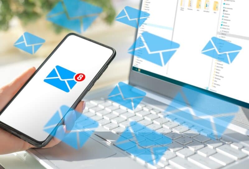 cell phone and laptop with lots of message icons