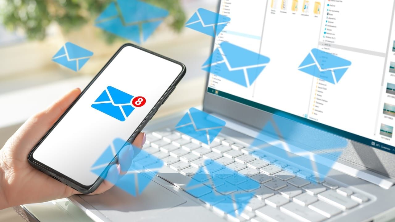 cell phone and laptop with lots of message icons