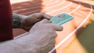 man hand with tracking app on mobile phone