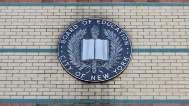 Board of Education City of New York Emblem Hangs on the Side of a Brown, Beige, and Green Brick Manhattan School Building in Uptown Washington Heights