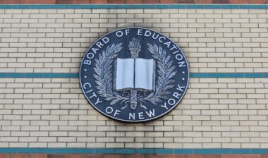 Board of Education City of New York Emblem Hangs on the Side of a Brown, Beige, and Green Brick Manhattan School Building in Uptown Washington Heights