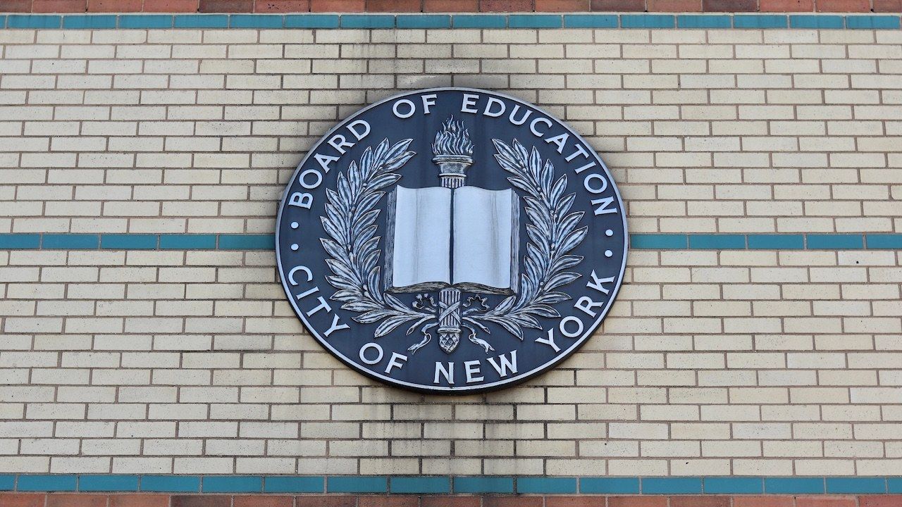 Board of Education City of New York Emblem Hangs on the Side of a Brown, Beige, and Green Brick Manhattan School Building in Uptown Washington Heights