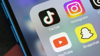 TikTok, Instagram, YouTube, and Snapchat app icons are seen on an iPhone.