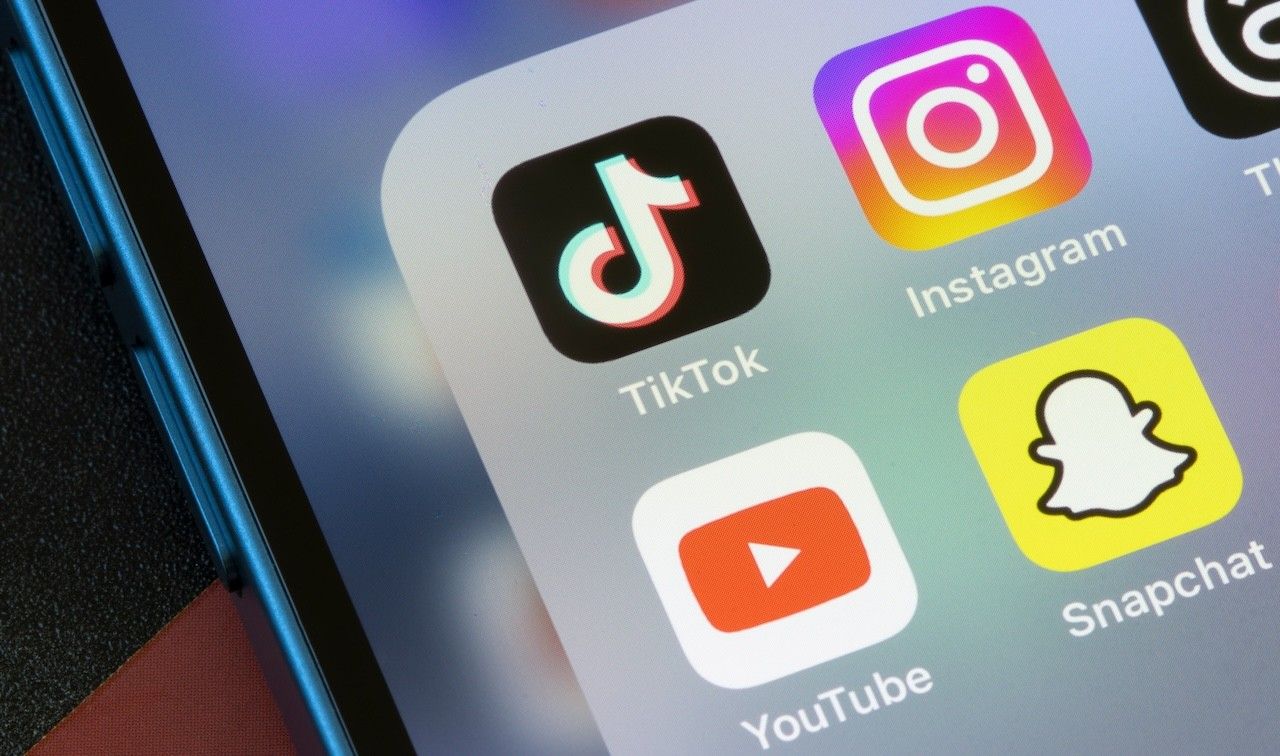 TikTok, Instagram, YouTube, and Snapchat app icons are seen on an iPhone.