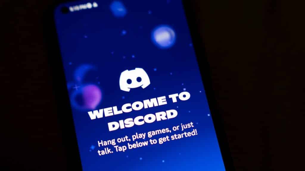 A smartphone screen displays the Discord app.