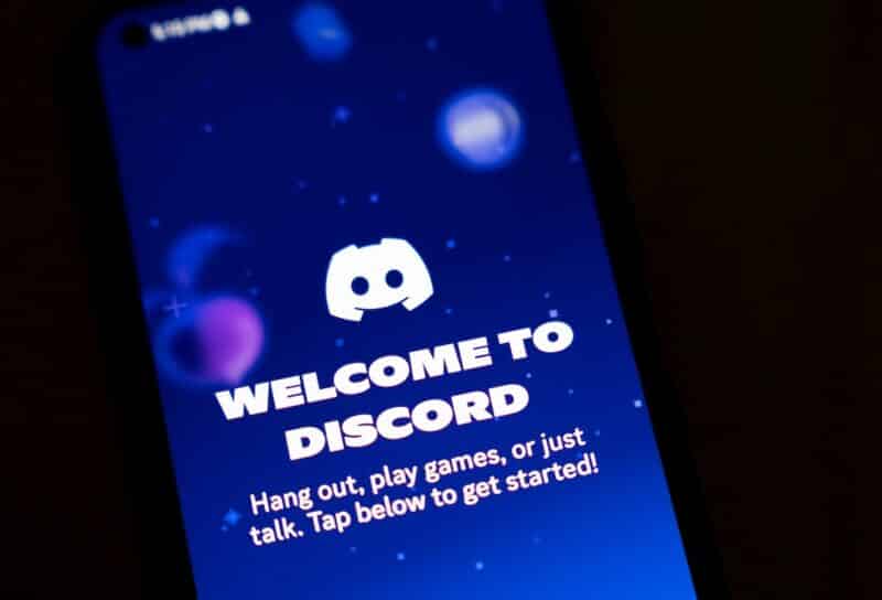 A smartphone screen displays the Discord app.