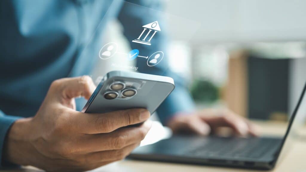 Business professional using smartphone for mobile banking with digital bank interface, representing online payment, secure transaction and financial technology innovation concept.
