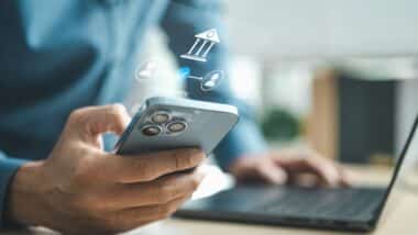Business professional using smartphone for mobile banking with digital bank interface, representing online payment, secure transaction and financial technology innovation concept.