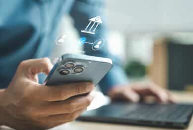Business professional using smartphone for mobile banking with digital bank interface, representing online payment, secure transaction and financial technology innovation concept.