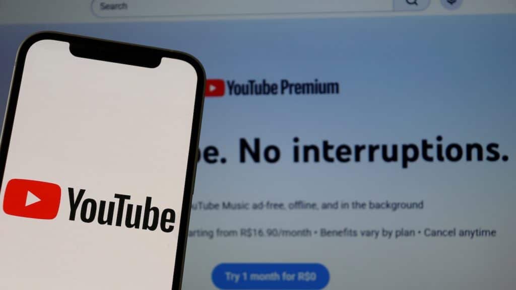 YouTube logo on a smartphone screen with the YouTube Premium interface in the background.