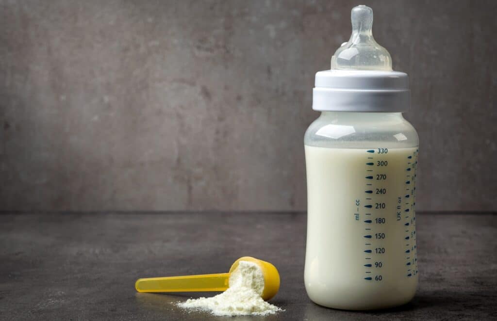 bottle of baby milk on dark grey table