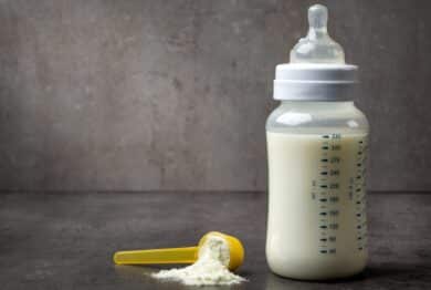 bottle of baby milk on dark grey table