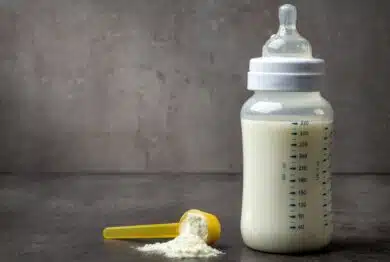 bottle of baby milk on dark grey table