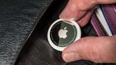 Apple AirTag device inserted into a leather purse as concept for stalking or secret tracking of a person