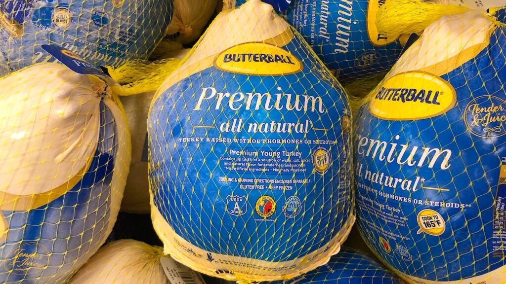 Grocery store freezer shelf with Butterball brand frozen turkeys.