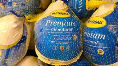 Grocery store freezer shelf with Butterball brand frozen turkeys.