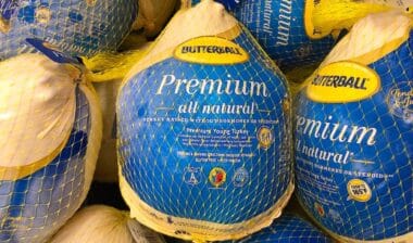 Grocery store freezer shelf with Butterball brand frozen turkeys.