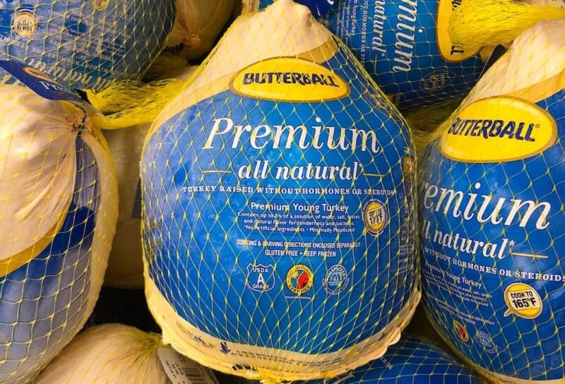 Grocery store freezer shelf with Butterball brand frozen turkeys.