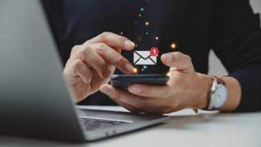 Hand of businessman using smartphone for email with notification alert, Online communication concept.