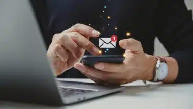 Hand of businessman using smartphone for email with notification alert, Online communication concept.
