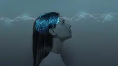 Young girl with closed eyes and neon glowing brain.