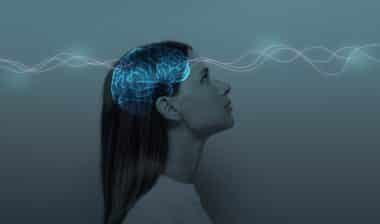 Young girl with closed eyes and neon glowing brain.