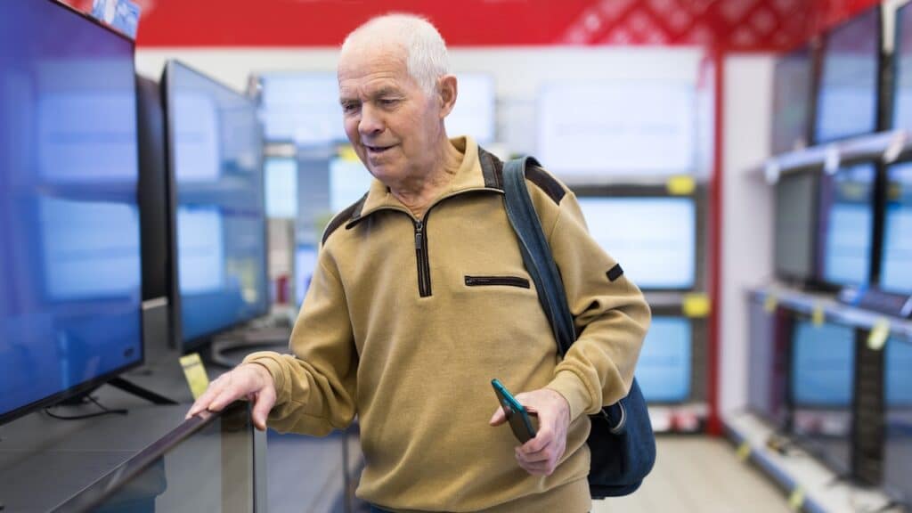 senor man pensioner buying modern digital televisor