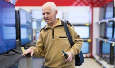 senor man pensioner buying modern digital televisor
