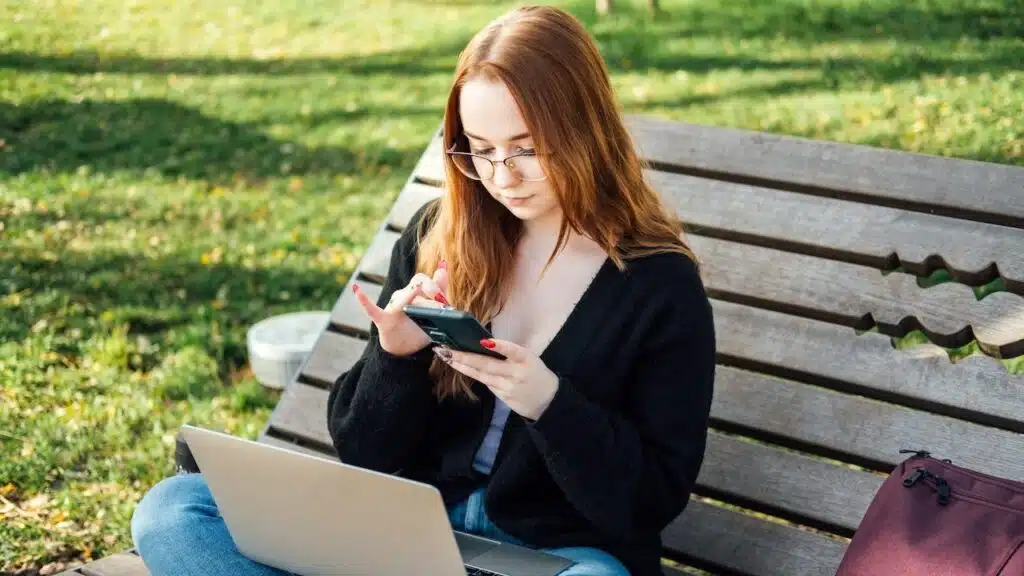 Student girl with laptop using chatbot for studying process