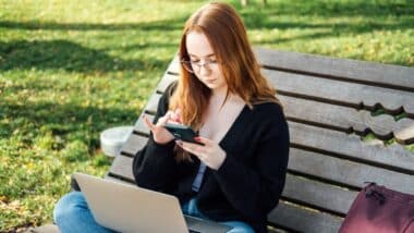 Student girl with laptop using chatbot for studying process