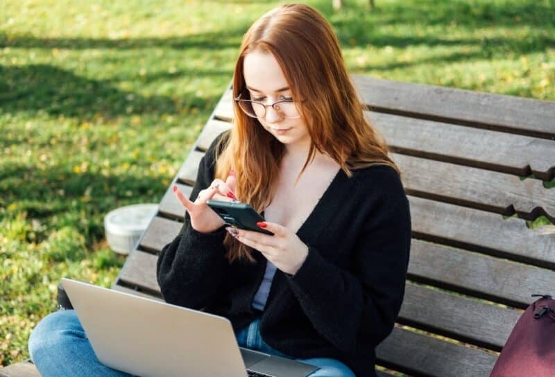 Student girl with laptop using chatbot for studying process