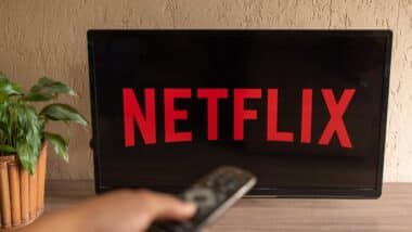 TV Television Netflix logo on screen with home remote control.