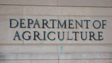 Exterior of Building of Department of Agriculture and a metallic writing that says Department of Agriculture on stones