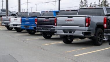 A row of luxury new General Motors Corporation Sierra 1500 trucks for sale at an automotive dealership lot.