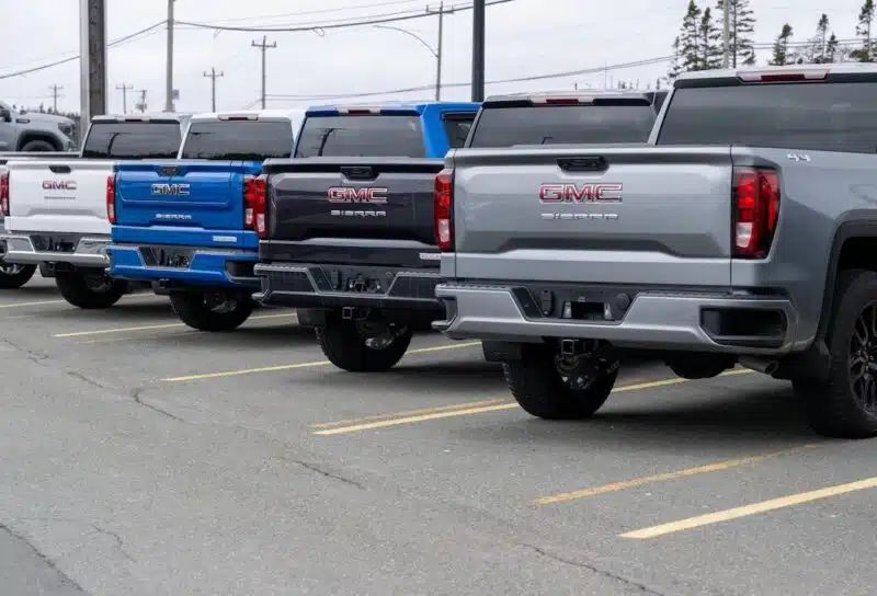 A row of luxury new General Motors Corporation Sierra 1500 trucks for sale at an automotive dealership lot.