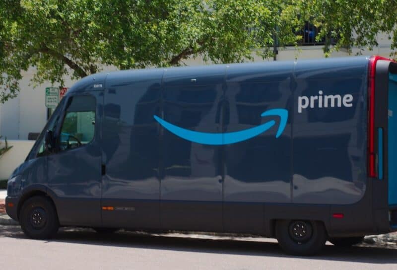 Branded Dark Blue Amazon Delivery Van from an Online Logistics Service in a Residential Area