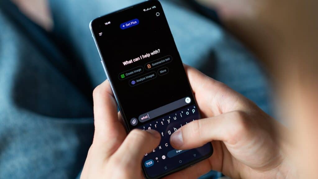 Close-up of a person using a smartphone with the ChatGPT app open.