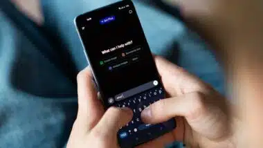 Close-up of a person using a smartphone with the ChatGPT app open.