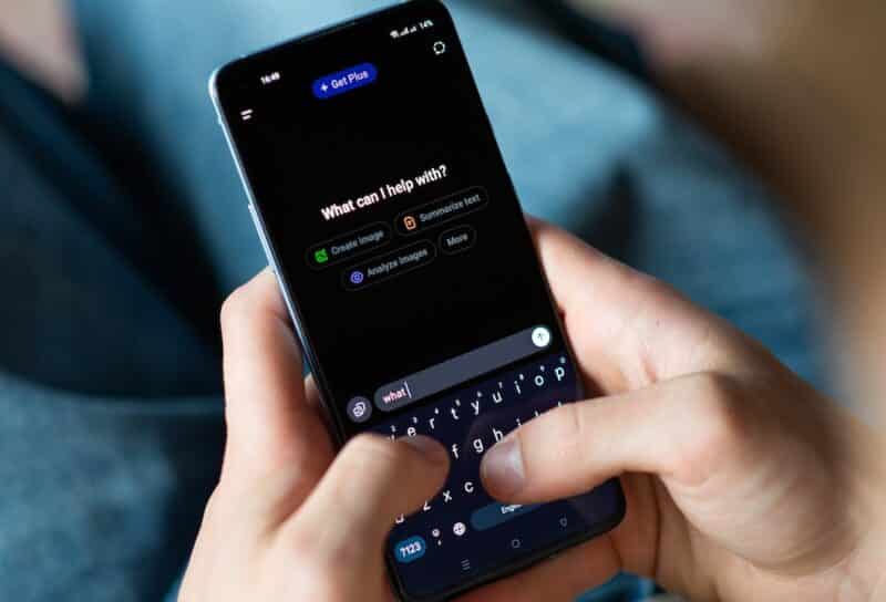 Close-up of a person using a smartphone with the ChatGPT app open.