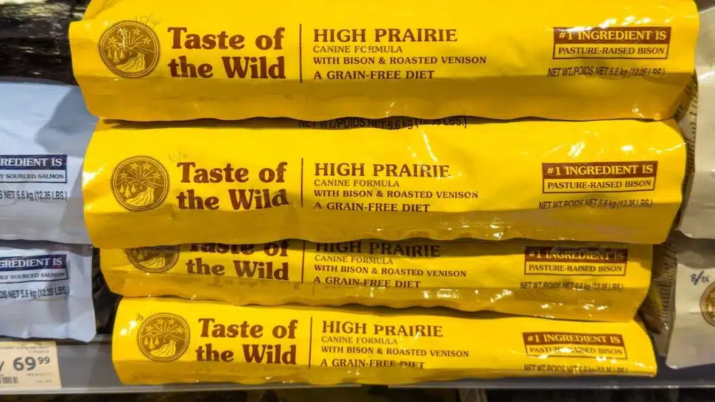 Taste of the Wild High Prairie dog food bags displayed on a retail shelf, featuring bison and roasted venison ingredients for dogs