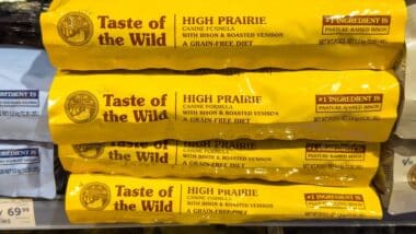 Taste of the Wild High Prairie dog food bags displayed on a retail shelf, featuring bison and roasted venison ingredients for dogs