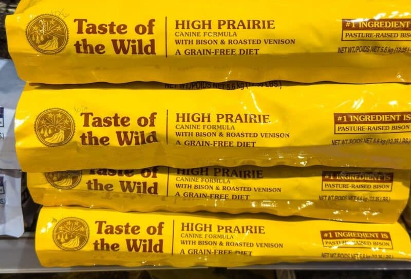 Taste of the Wild High Prairie dog food bags displayed on a retail shelf, featuring bison and roasted venison ingredients for dogs